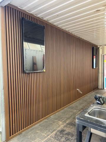 Timber-look slat wall interior with servery window